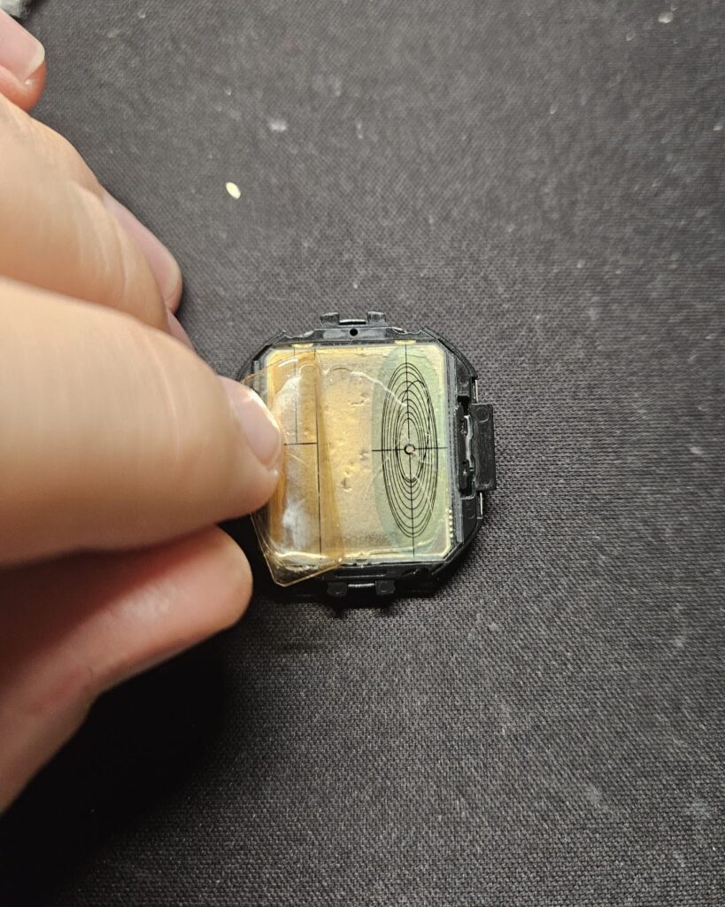 Removing protective film from Casio CGW-50 Cosmo Phase dial during restoration.