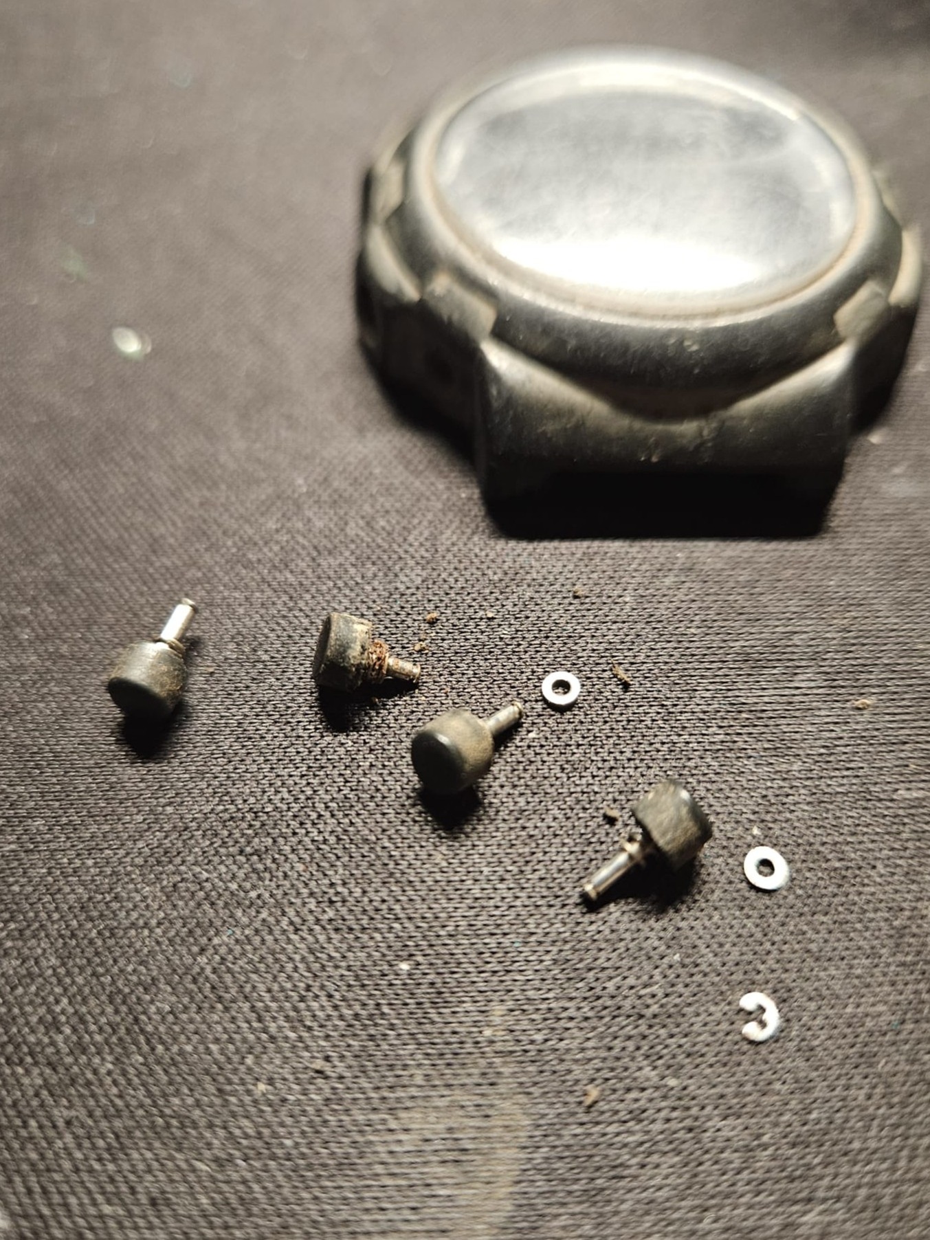 Removed push buttons and washers from Casio CGW-50 Cosmo Phase watch during cleaning.