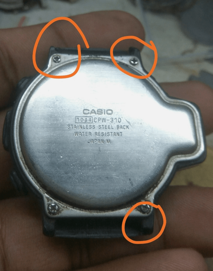 Casio CPW-310 watch case back showing three broken lugs marked in red.