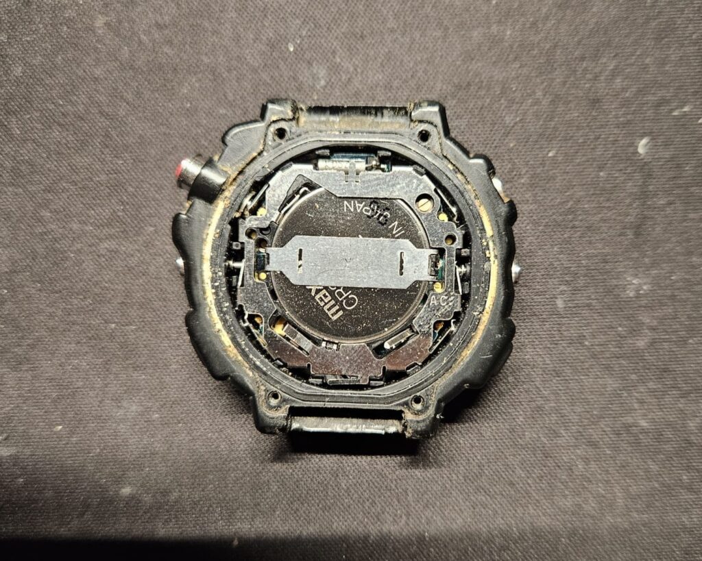 Inside view of Casio STR-1000 watch with battery compartment exposed.
