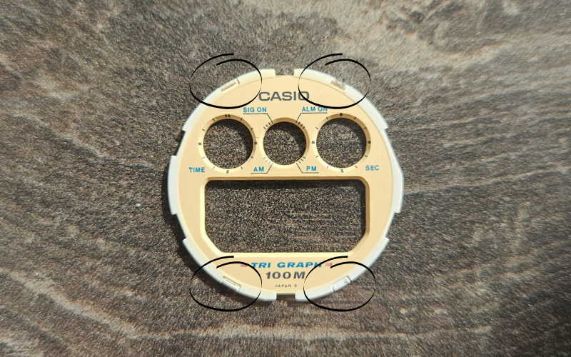 Casio TGW-10 faceplate removed, showing plastic contact points used to mount the bezel.