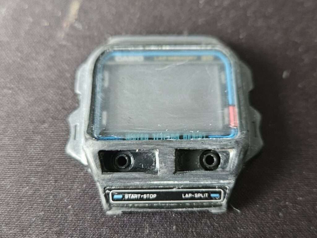 Close-up of a Casio SDB-500 front case during cleaning and restoration work.