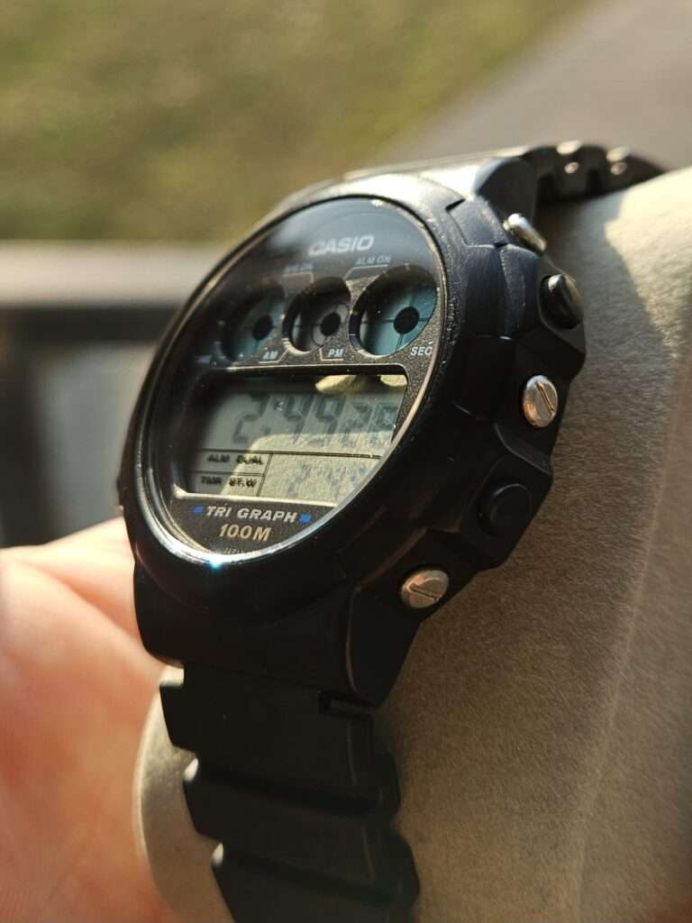 Angled view of Casio TGW-10 Tri Graph digital watch showing side buttons and case depth