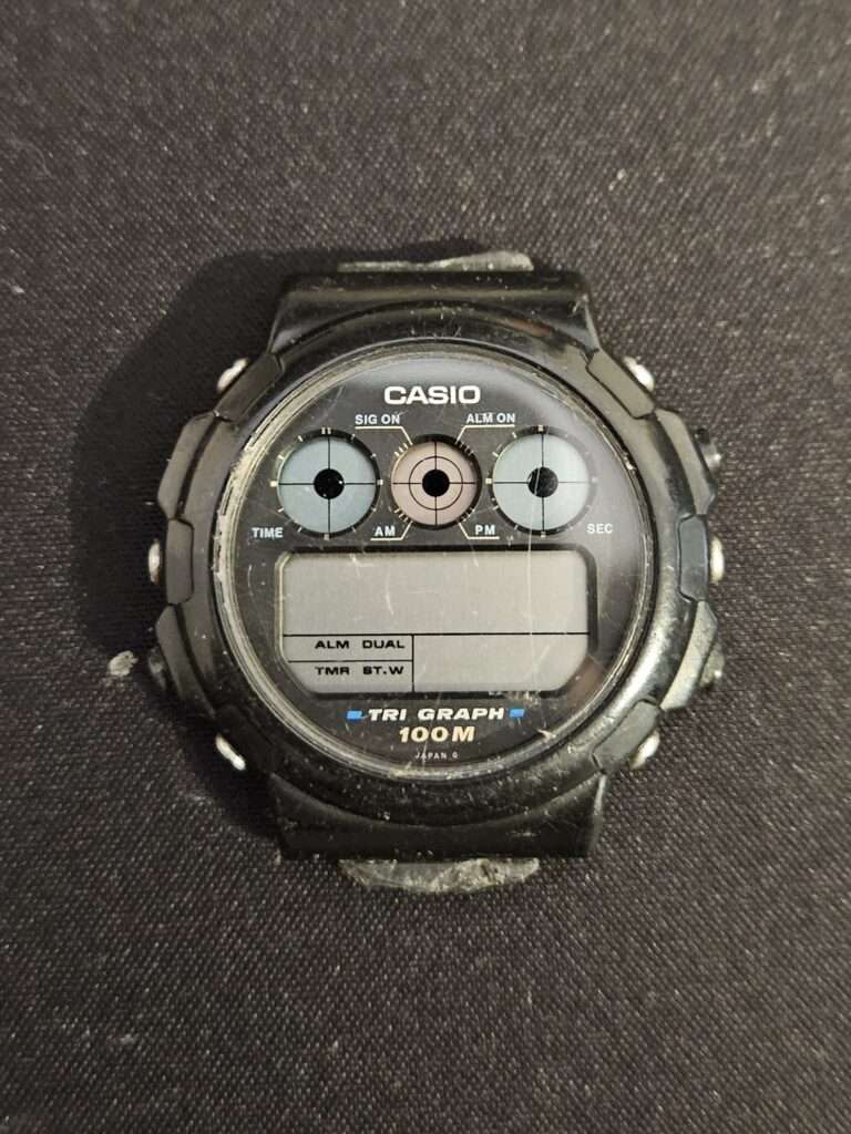 Angled front view of Casio TGW-10 Tri Graph watch showing signs of use
