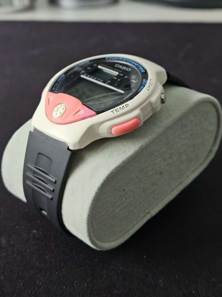 Restored Casio TS-200 Casio Thermometer watch on display cushion, white case with pink accents and black strap
