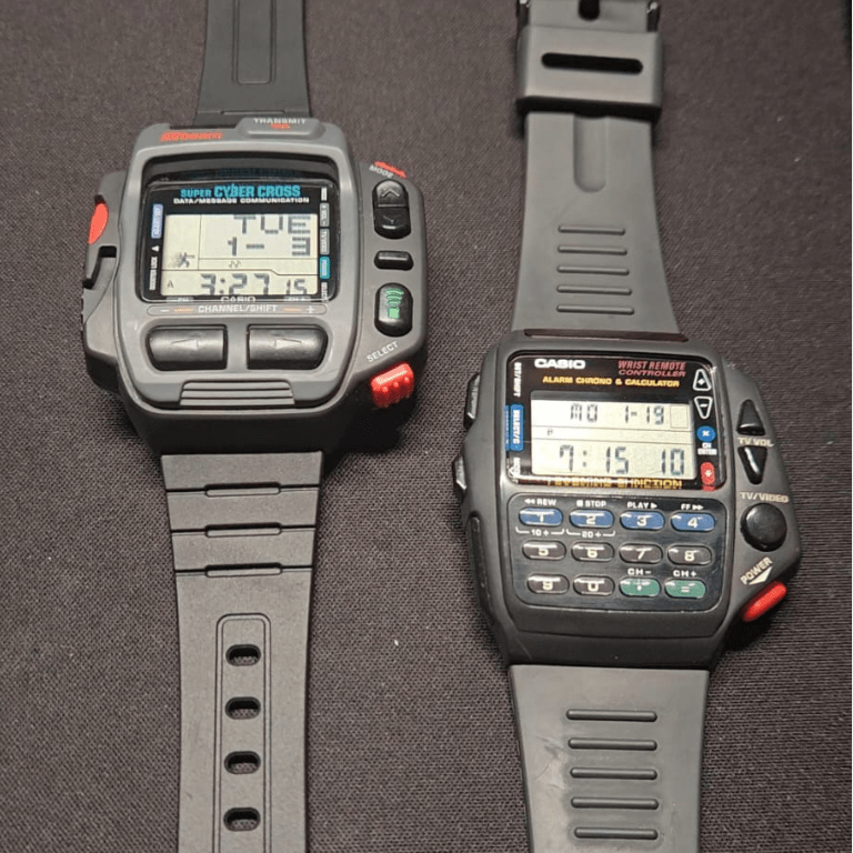 Casio CMD-40 and JG-200 vintage digital watches fully restored, displayed side by side on dark surface