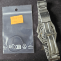 Casio W-720 stainless steel watch case open with sourced gasket in bag, prepared for full service