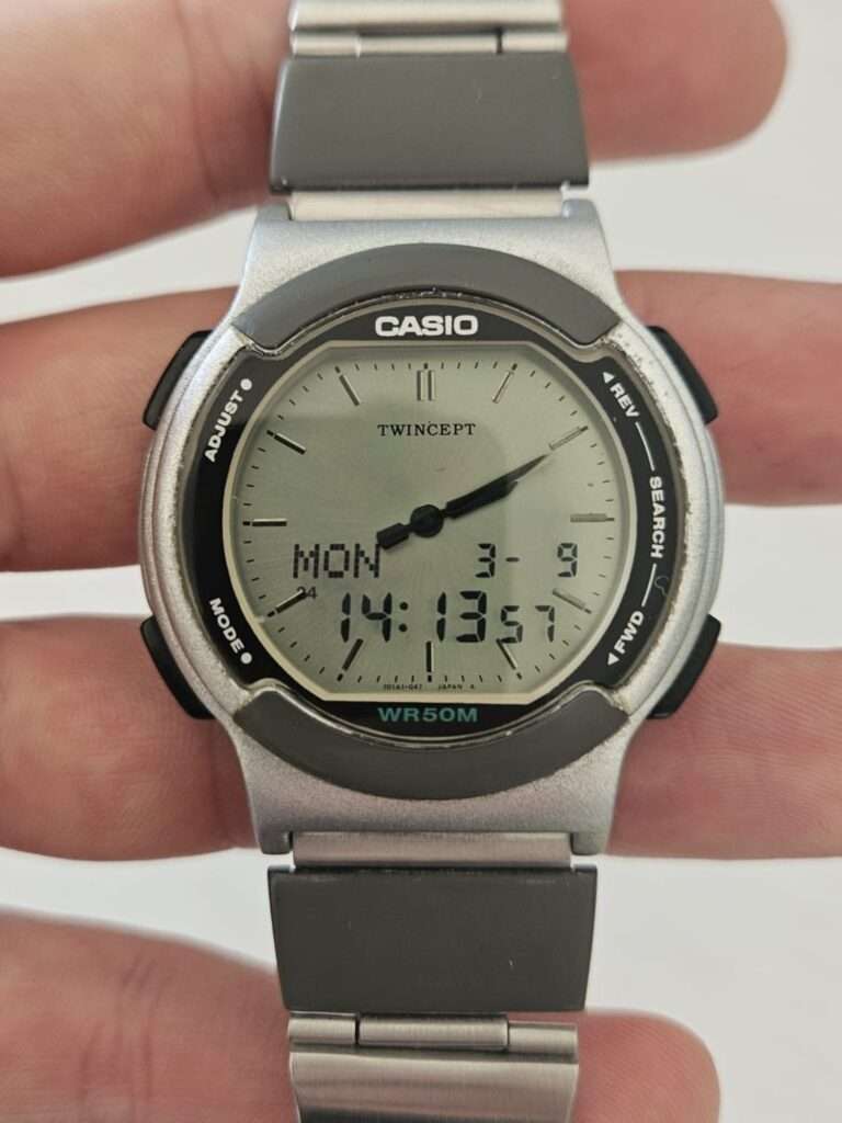 Casio ABX-53 Twincept held in hand, clear polished crystal, digital display MON 3-9 14:13:57, TWINCEPT logo, WR50M, post-restoration