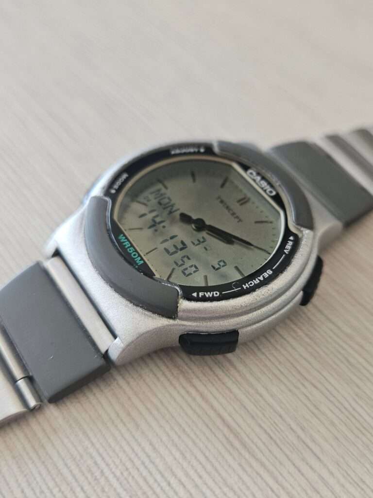 Casio ABX-53 Twincept analog-digital watch angled view with clear polished crystal, digital display showing MON 14:13, WR50M, post-restoration