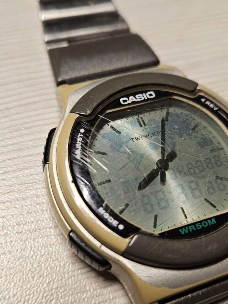 Casio ABX-53 Twincept analog-digital watch dial with heavy scratches on crystal, WR50M marking, pre-restoration