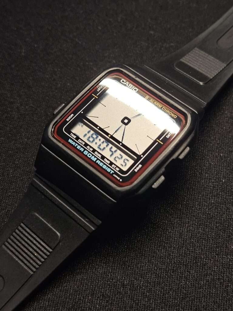 Restored Casio AE-11W Alarm Chrono diagonal view with polished crystal displaying time 18:07:25 after restoration