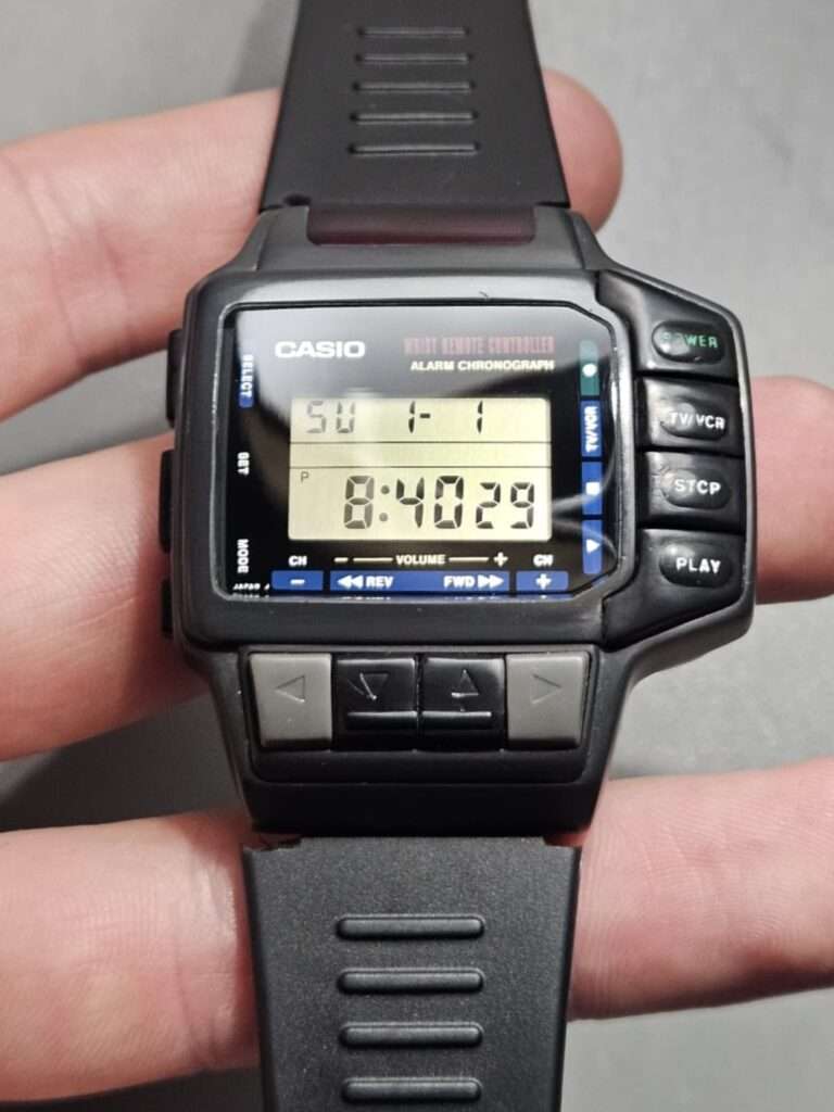 Casio CMD-10 alarm chronograph wrist remote controller held in hand showing restored black case and clear LCD after restoration