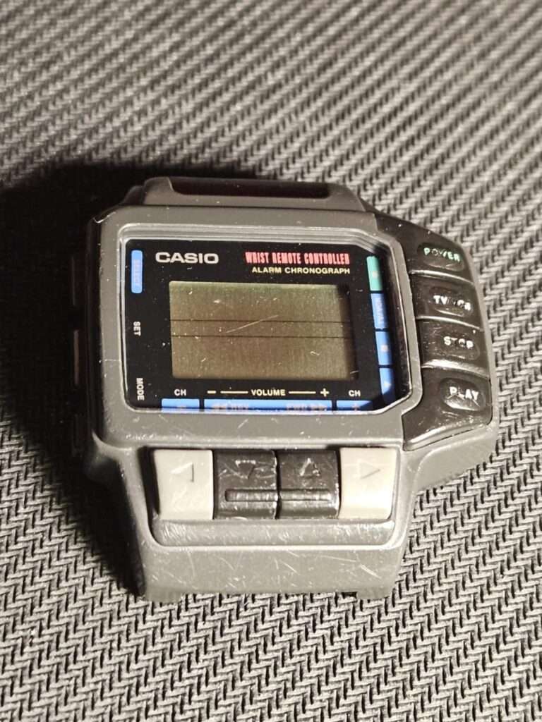 Casio CMD-10 alarm chronograph wrist remote controller angled front view before restoration showing LCD and directional buttons