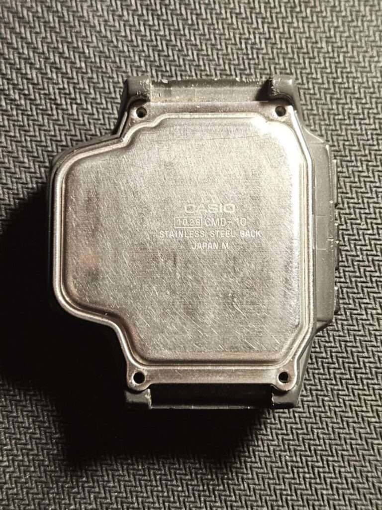 Casio CMD-10 stainless steel case back engraved with model number 1029 and Japan M marking before restoration