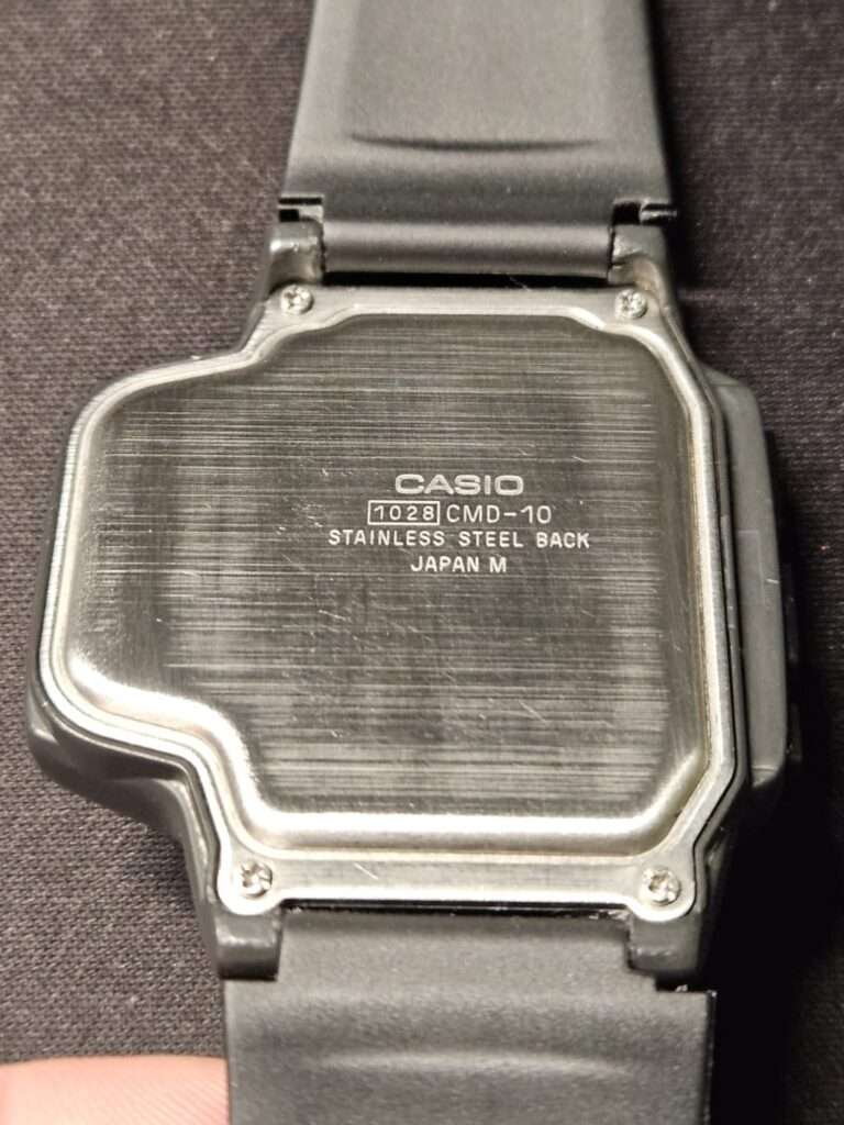 Casio CMD-10 stainless steel case back engraved with 1028 CMD-10 Japan M marking after restoration on black strap