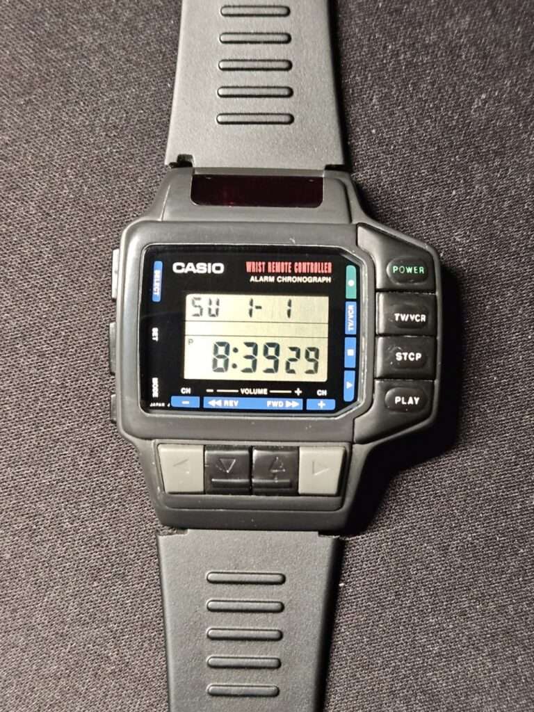 Casio CMD-10 wrist remote controller alarm chronograph front view after restoration, clean black resin case with working LCD display showing time