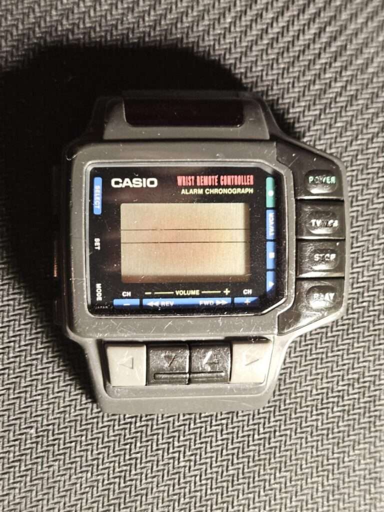 Casio CMD-10 wrist remote controller alarm chronograph front view before restoration, worn gray plastic case