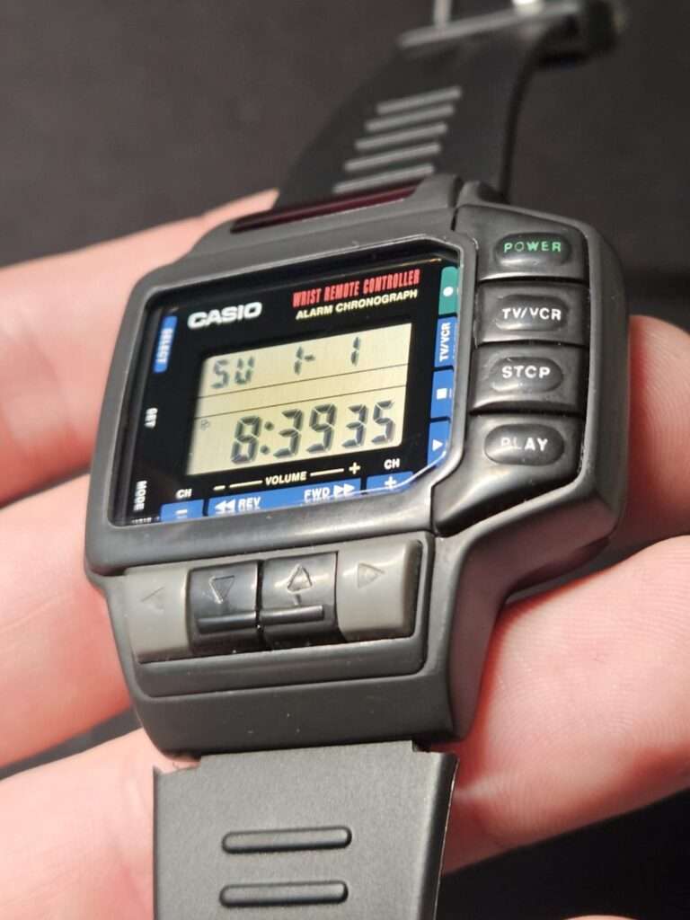 Casio CMD-10 wrist remote controller held in hand after restoration, LCD displaying time 8:39:35 with all buttons restored