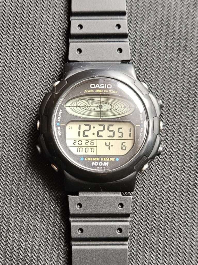 Casio CGW-50 Cosmo Phase after restoration laid flat on black strap with planetary dial and clear crystal