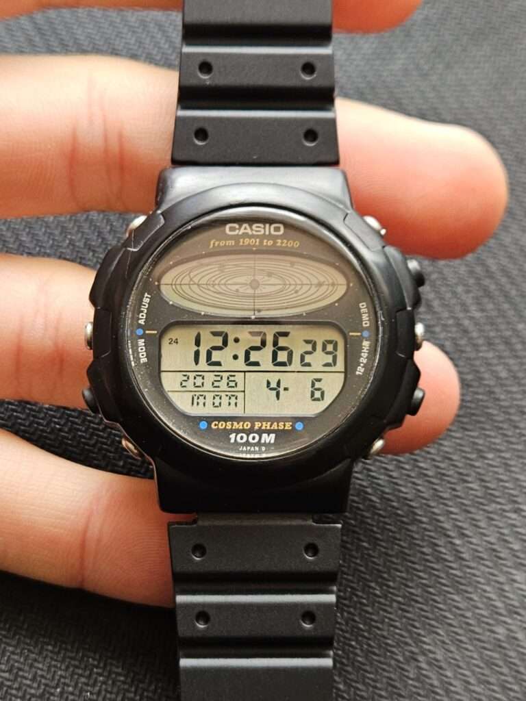 Casio CGW-50 Cosmo Phase after restoration held in hand, new acrylic crystal, active LCD dial showing time and date
