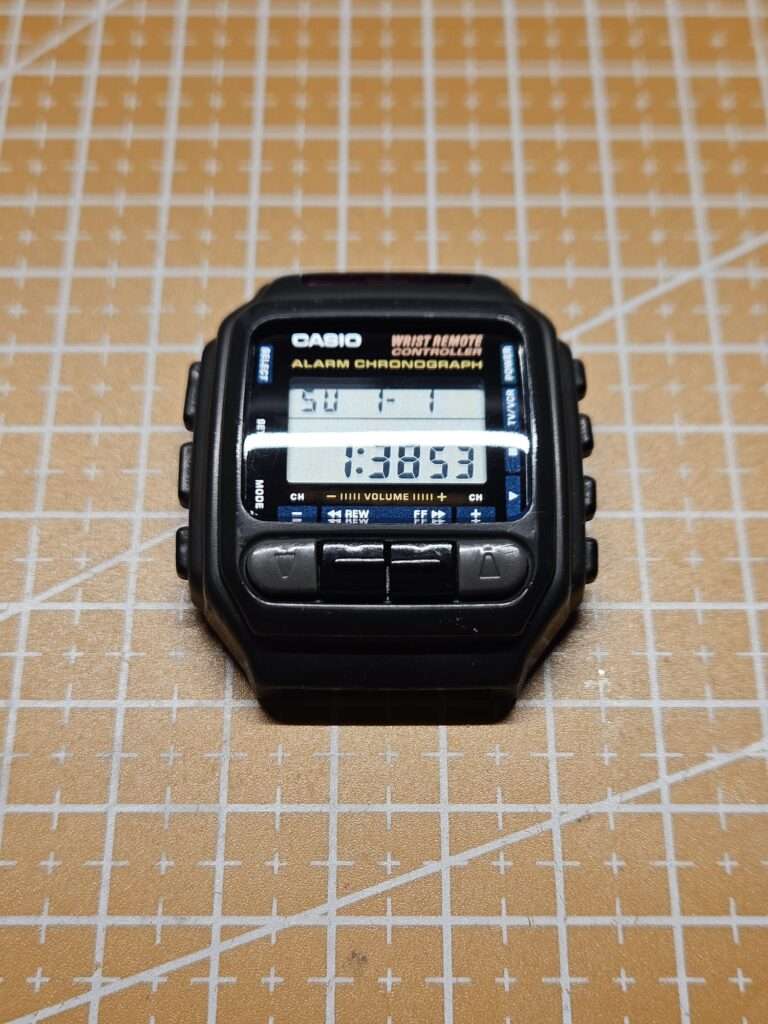 Restored Casio CMD-30 Alarm Chronograph Wrist Remote Controller with working LCD on orange cutting mat after restoration