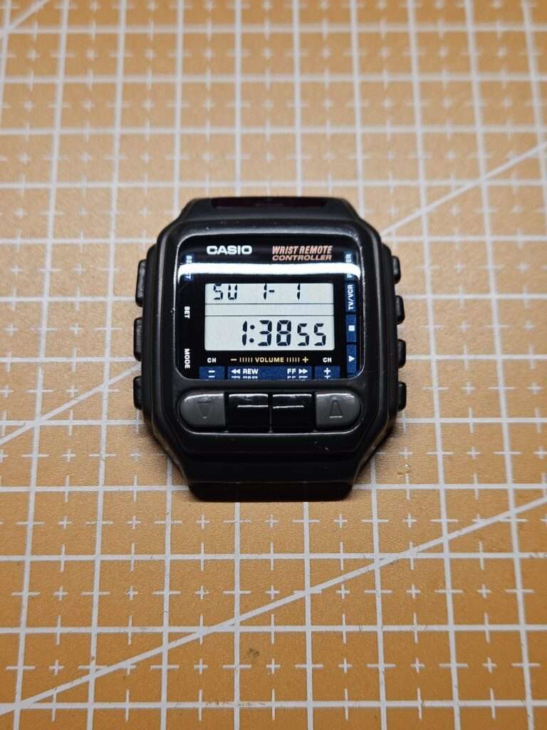 Fully restored Casio CMD-30 Wrist Remote Controller with new crystal showing clear LCD reading 1:38:55 on cutting mat