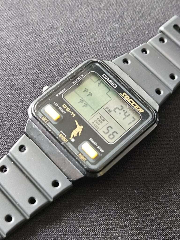 Casio GS-11 Soccer game watch case fitted with Casio SDB-500 black rubber strap before restoration, angled flat lay