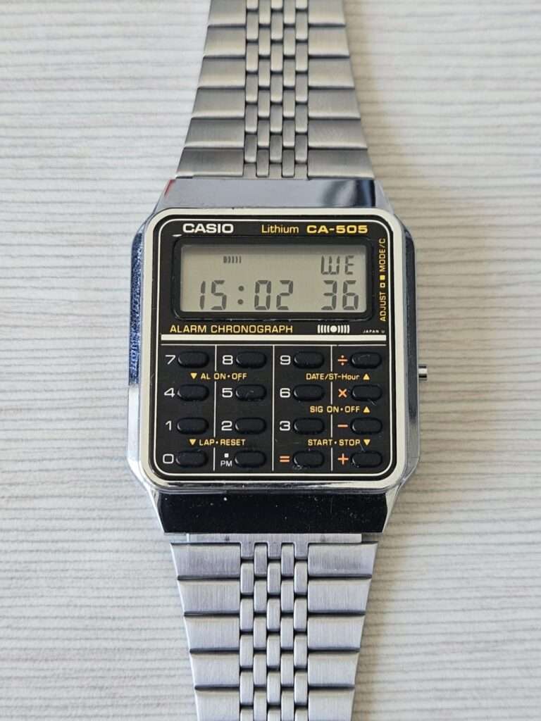 Casio CA-505 Lithium Alarm Chronograph calculator watch after restoration, front flat-lay view on white surface
