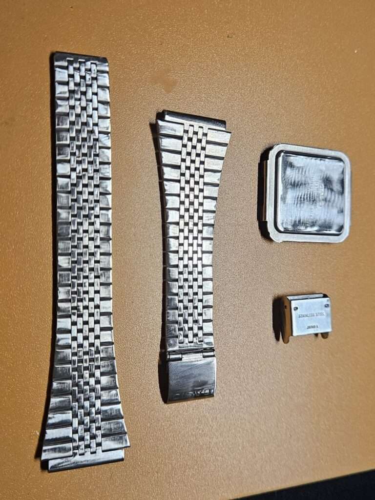 Casio CA-505 stainless steel bracelet and case back disassembled for scratch removal via sanding