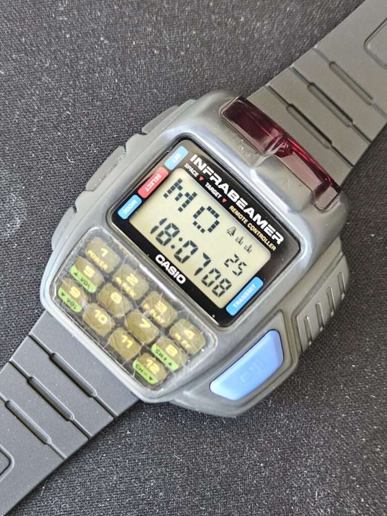 Casio JG-10 Infrabeamer remote controller watch after restoration with active LCD display showing time and resin-coated keypad