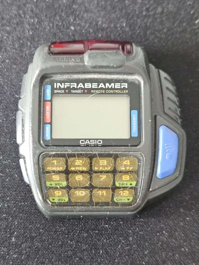 Casio JG-10 Infrabeamer watch front view with red infrared emitter on top and cracked keypad before restoration