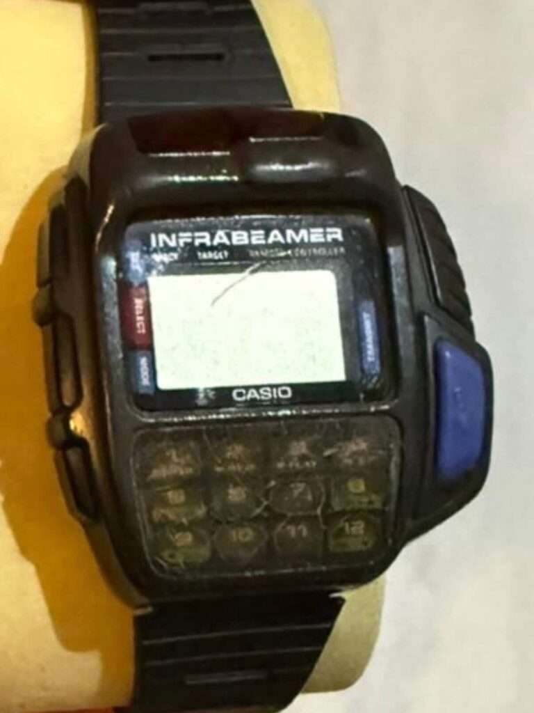 Casio JG-10 Infrabeamer watch worn on wrist with severely degraded LCD and cracked keypad before restoration