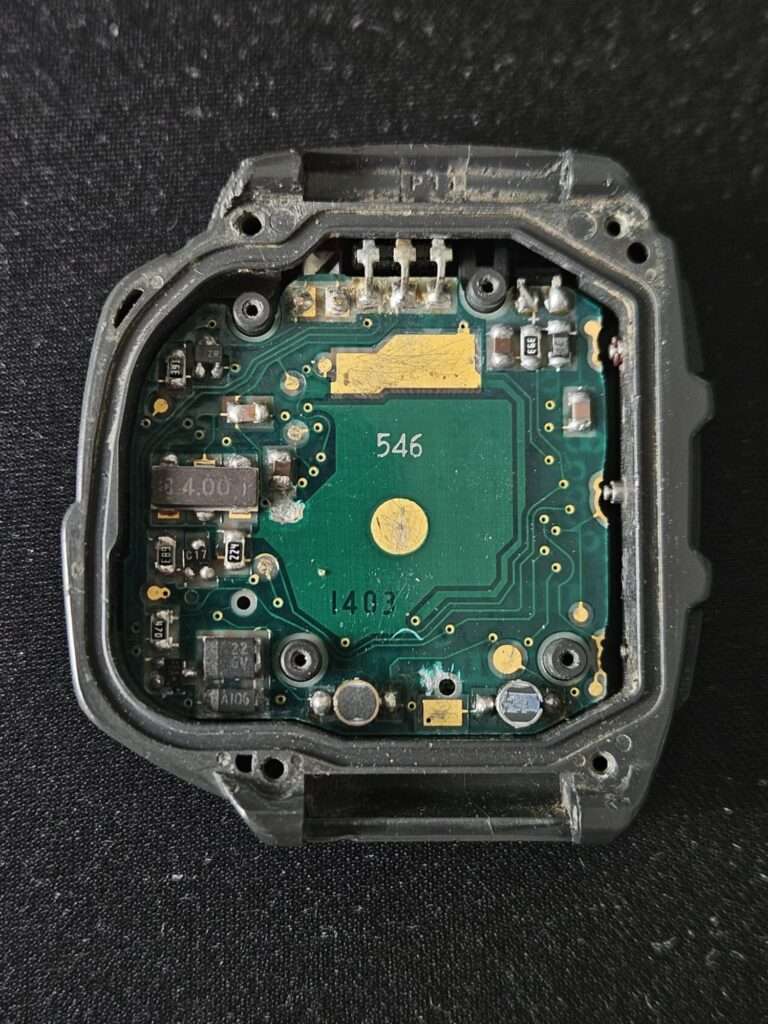 Casio JG-10 module 1403 green PCB with SMD components and IR emitter leads exposed inside case before restoration