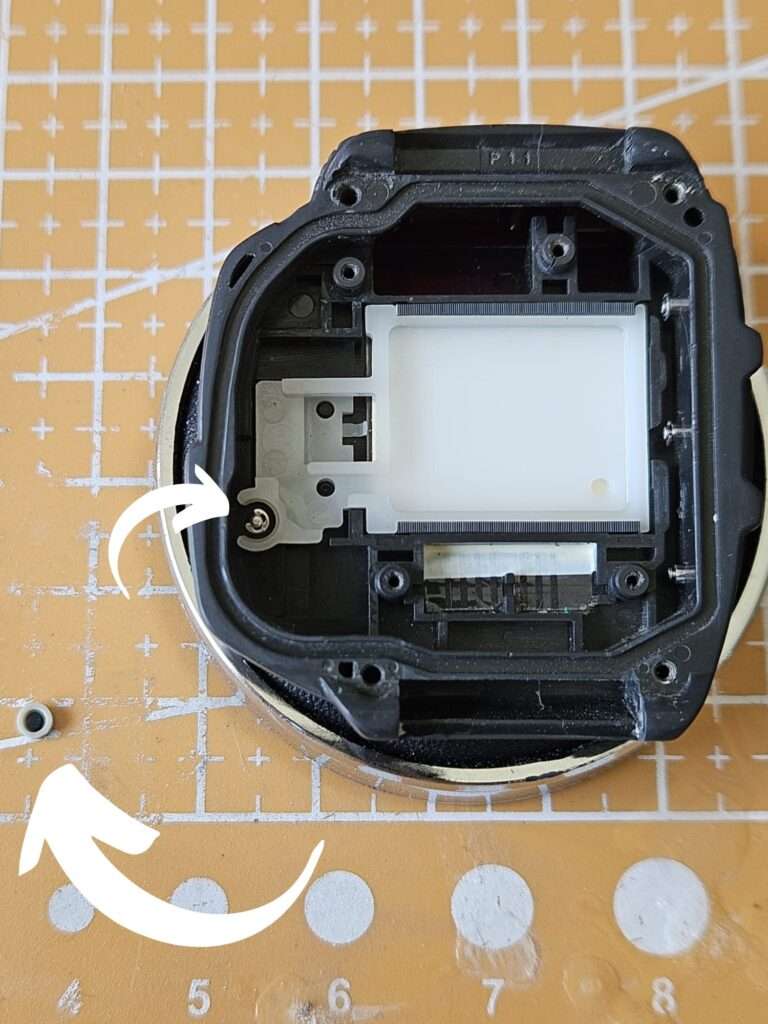 Casio JG-10 watch case open during restoration with missing button gasket replaced, LCD module and connector ribbon visible