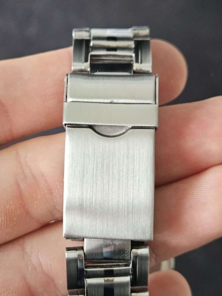Polished Casio CGW-500 Cosmo Phase fold-over bracelet clasp held in hand after restoration