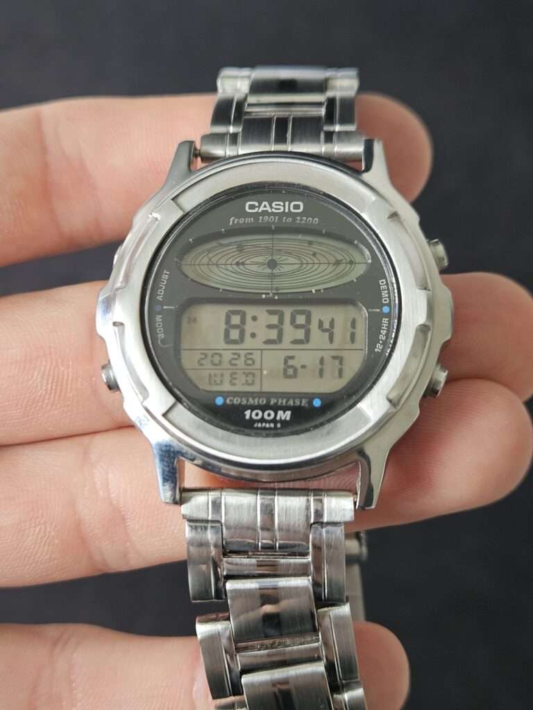 Restored Casio CGW-500 Cosmo Phase digital watch front view, clean display reading 8:39 with polished steel case