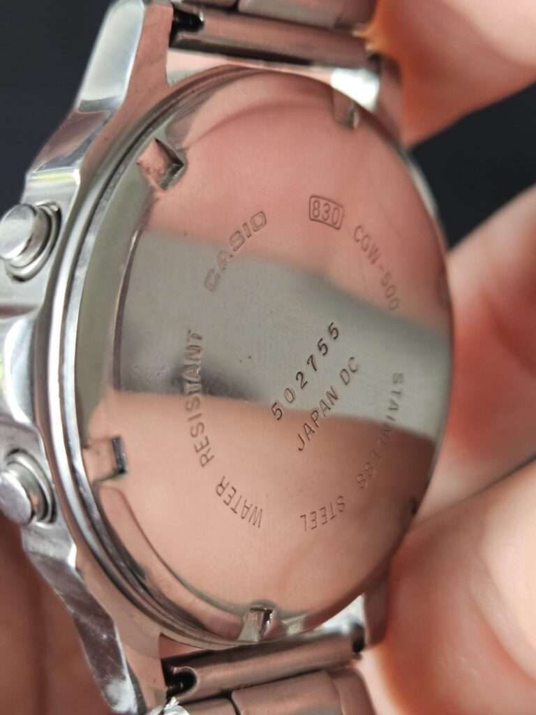Casio CGW-500 caseback markings showing model CGW-500, module 830, serial 502755, Japan DC and stainless steel