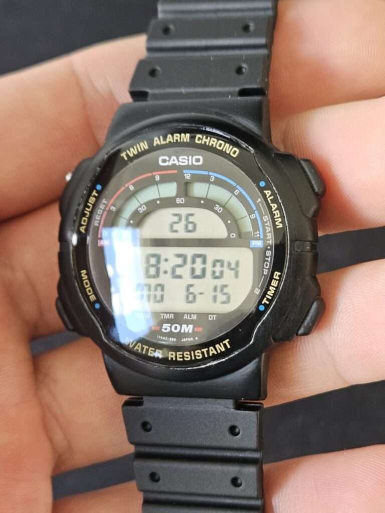 Restored Casio W-95 Twin Alarm Chrono digital watch held in hand with clear crystal showing 8:20 and date