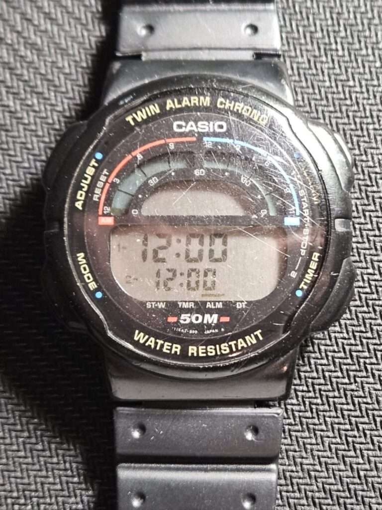 Casio Twin Alarm Chrono W-95 digital watch front face with scratched crystal and 50M water resistant marking