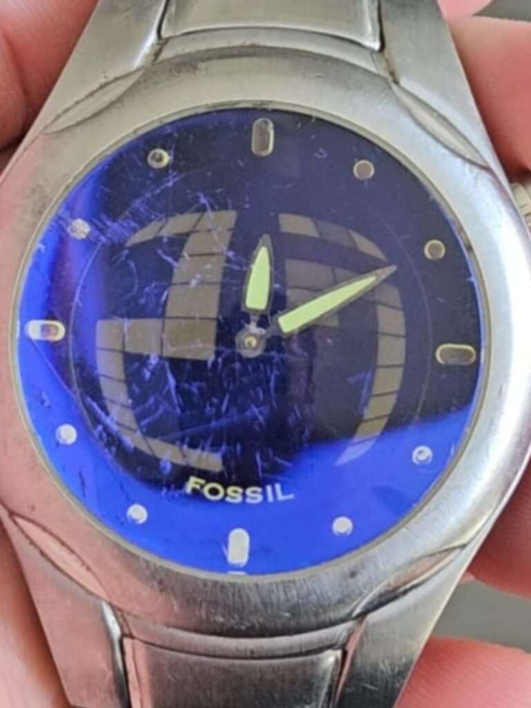 Fossil Big Tic JR8096 close-up of blue globe dial with green lume hands and mixed hour markers, worn crystal