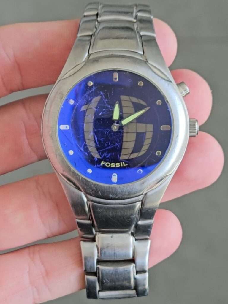 Fossil Big Tic JR8096 front view, blue dial with globe pattern, green lume hands, stainless steel case and bracelet, used condition