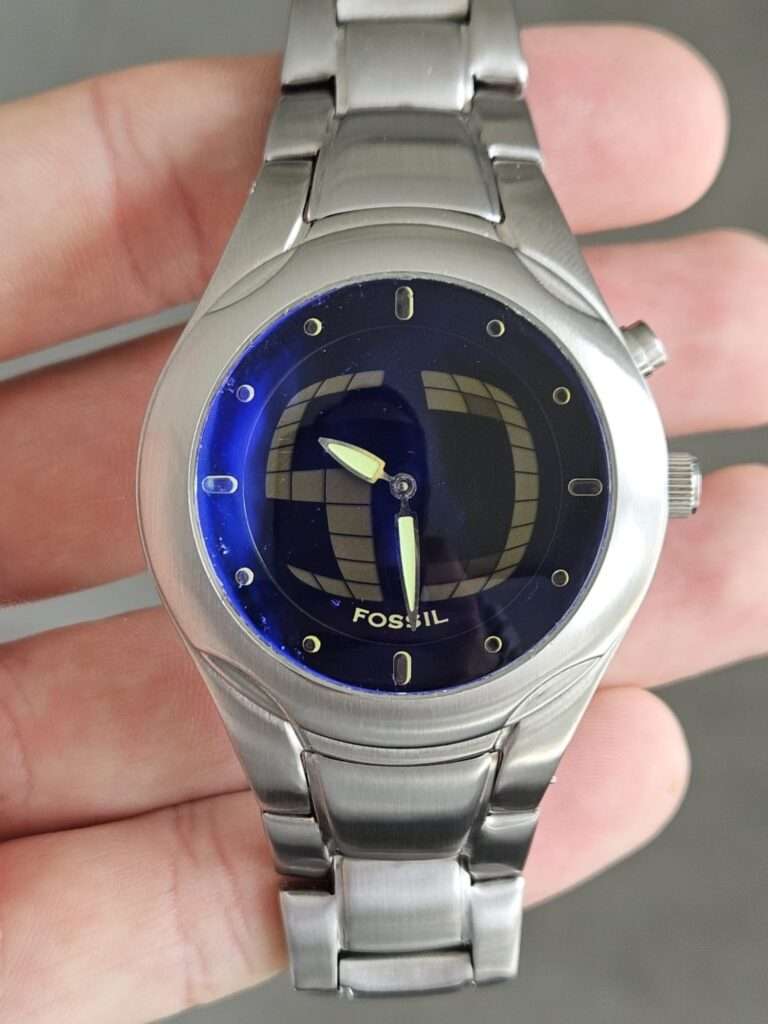 Fossil Big Tic JR8096 restored front view, blue globe dial with gold hour markers and green lume hands, brushed bracelet