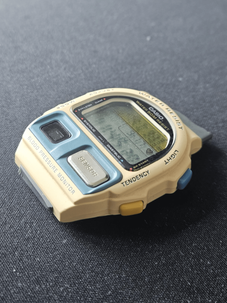 Casio BP-100 blood pressure watch before restoration with yellowed cream case