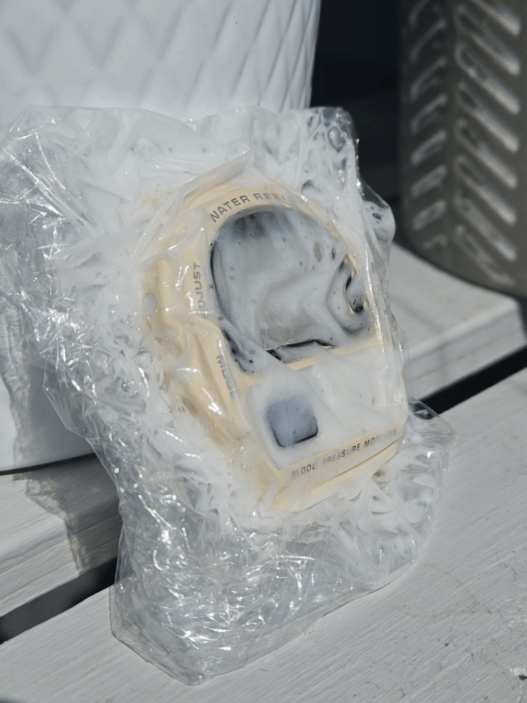 Casio BP-100 case wrapped in plastic for UV and oxidant whitening treatment