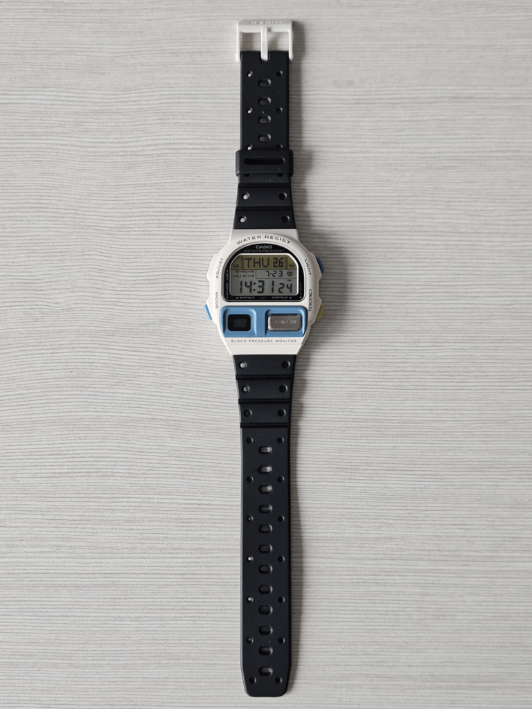 Casio BP-100 restored white watch laid flat with black resin strap