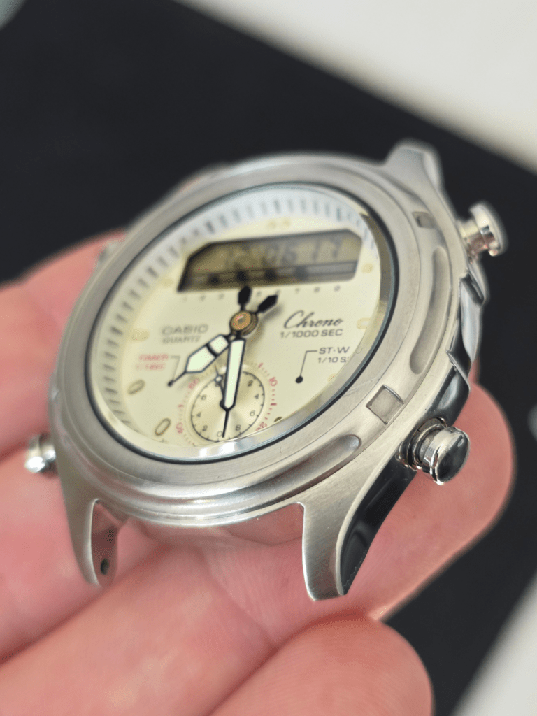 Angled view of restored Casio Chrono AW-600 watch dial and stainless steel case