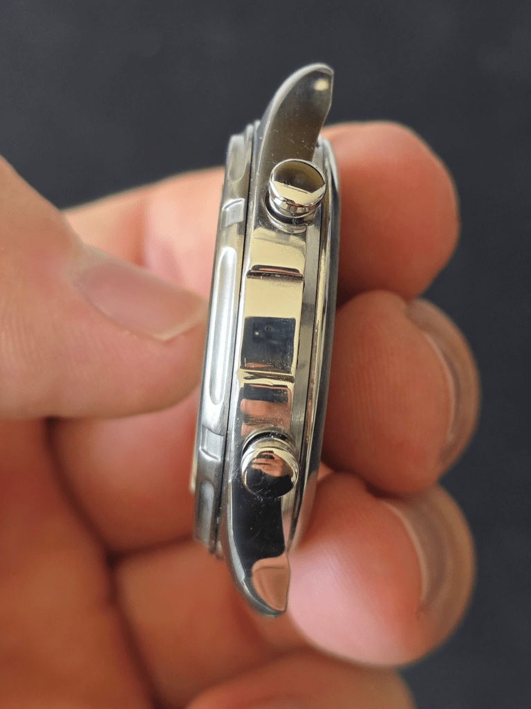 Close-up of Casio AW-600 crown and chronograph pushers on polished stainless steel case