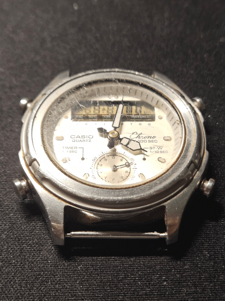 Casio AW-600 watch before restoration with cracked crystal and faded digital display