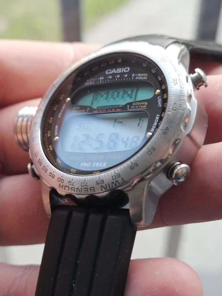 Restored Casio Pro Trek ALT-7000 watch lying flat with black rubber strap and clean bezel