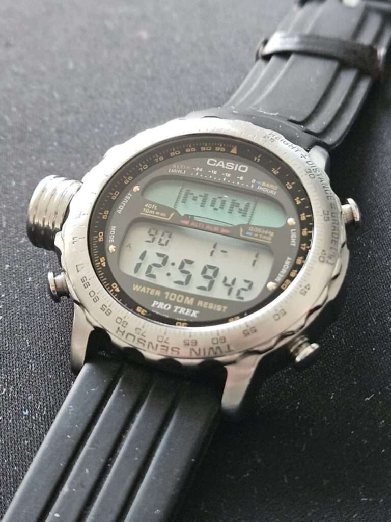 Restored Casio Pro Trek ALT-7000 digital watch held in hand with clean crystal and black strap